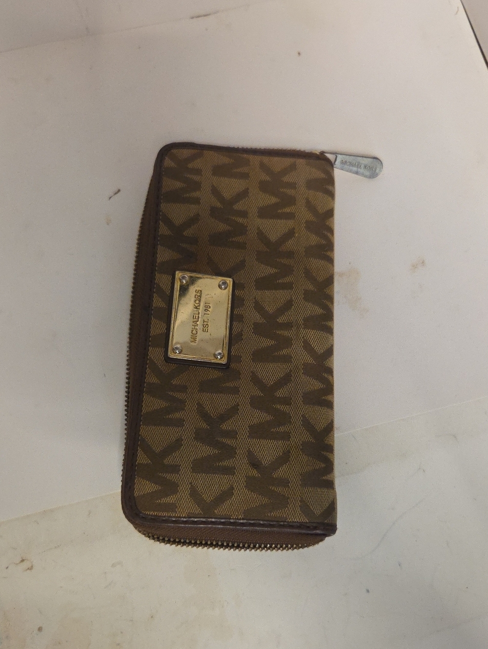 Michael Kors Jet Set Continental Logo Wallet featuring a zip-around design.
